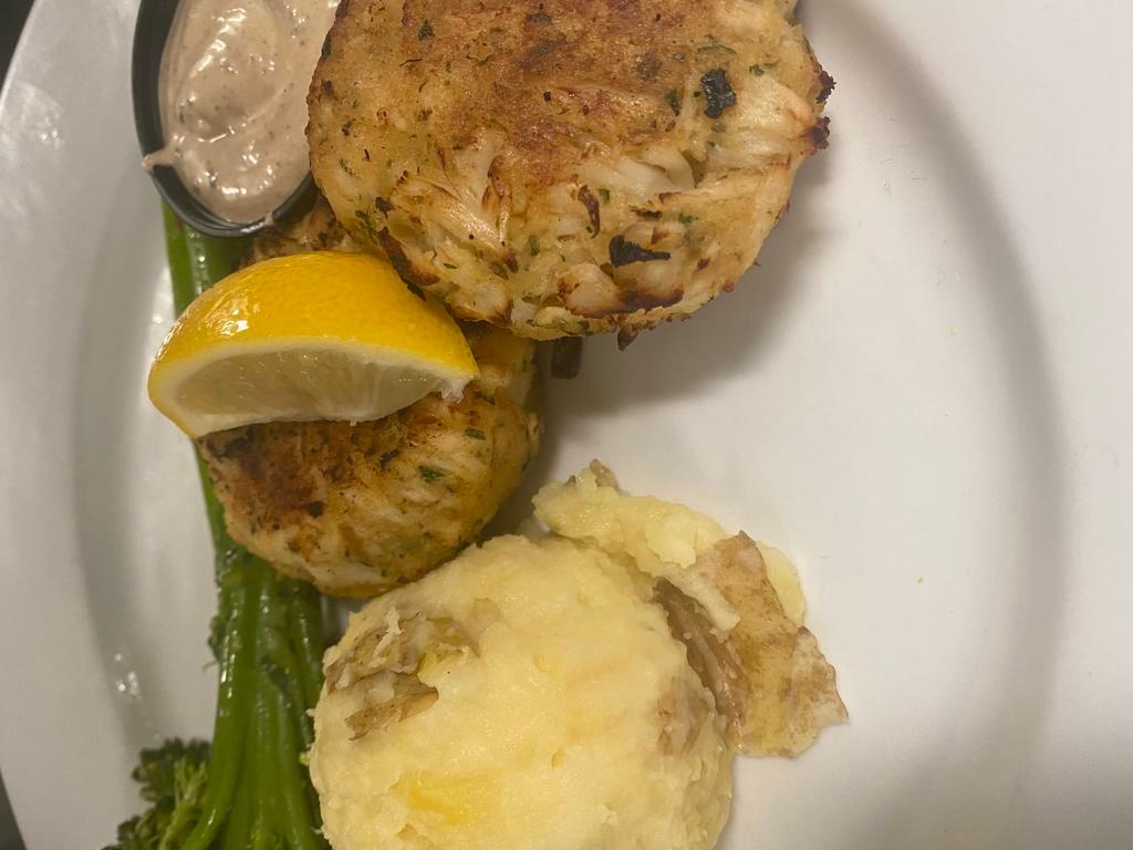 Crab Cakes  · 2 jumbo lump crab cakes, served with broccolini and mashed potatoes, with a side of remoulade sauce. 
