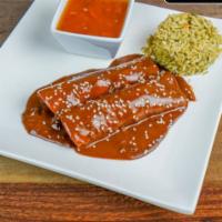 Enchiladas de Mole · 2 chicken enchiladas topped with mole sauce. Served with cilantro, lime, rice, and charro be...