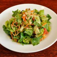 Asian Sesame Salad · Crisp romaine lettuce, Mandarin oranges, sliced almonds, crispy noodles, cucumbers, tomatoes...