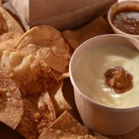 Chips & Queso  · Melted queso blanco, a touch of Molcajete Salsa and fresh chips, made in house!