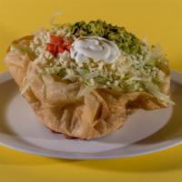 Taco Salad · Deep-fried flour tortilla with rice, beans lettuce, sour cream, and freshly made guacamole.