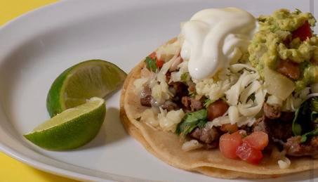 Super Taco · Served in a double corn tortilla, meat, pico de gallo, cheese, sour cream and guacamole, and lime slice.