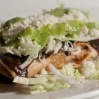 Taquitos Oaxaquenos · 4 pieces of single rolled deep-fried corn tortillas filled topped with black bean puree, cab...