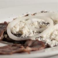 Enfrijoladas · 3 pieces of corn tortillas served with tasajo covered with our savory black puree, queso fre...