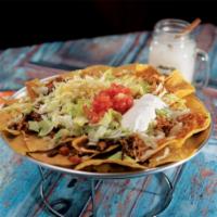 Nachos Alebrije · Nachos with assorted toppings cheese, beef, chicken and refried beans, all covered with jala...