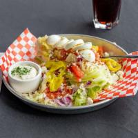 Iceberg Wedge Salad · Egg, bacon, tomato, red onion, diced pepperoncini, blue cheese crumbles and blue cheese dres...