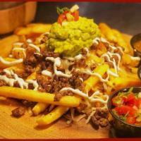Asada Fries · Topped with Sour Cream, Monterrey Jack Cheese and Guacamole