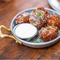 Mac and Cheese Balls · Beer cheese sauce, Fresno chiles, chives and Parmesan.