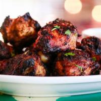 Char Grilled Hot Wings · All-natural, dry rubbed and marinated in Sriracha hot sauce, citrus, garlic and cilantro cha...