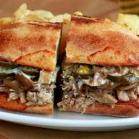 Cuban Pulled Pork Sandwich · With provolone, caramelized onions, jalapenos and aioli. Baked on ciabatta bread and served ...