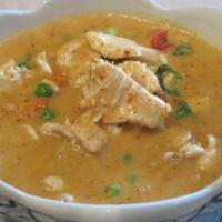 28. Panang Curry · Simmered in rich red panang curry paste in coconut milk with bell peppers, zucchini and basi...