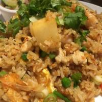 34. Pineapple Fried Rice · Stir fried rice with chicken, shrimp, cashew nuts, pineapple, onions and touch of curry powd...