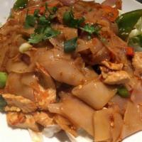 36. Drunken Noodles · Stir fried flat rice noodles with chili garlic, onions and basil leaves. Spicy.