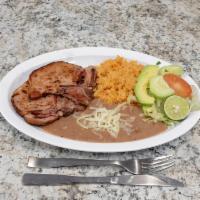 Chuleta Ahumada · Two smoked pork chops and 5 corn tortillas served with Mexican-style rice, refried beans, an...
