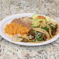 Taco Plate · 3 tacos of your choice of meat served by a side of rice, beans and a small salad.