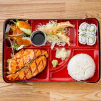 Salmon Teriyaki Bento Box · Rice, salad, 4 pieces of California Roll, 3 pieces of pork and vegetable gyoza (fried dumpli...