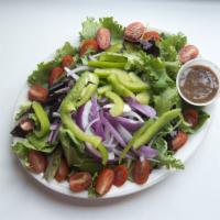House Salad · Mixed greens, artichokes, tomatoes and red onions with balsamic vinaigrette. Served with a s...