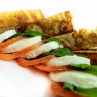 Caprese Salad · Fresh mozzarella and fresh tomatoes on basil leaves drizzled with olive oil and balsamic vin...