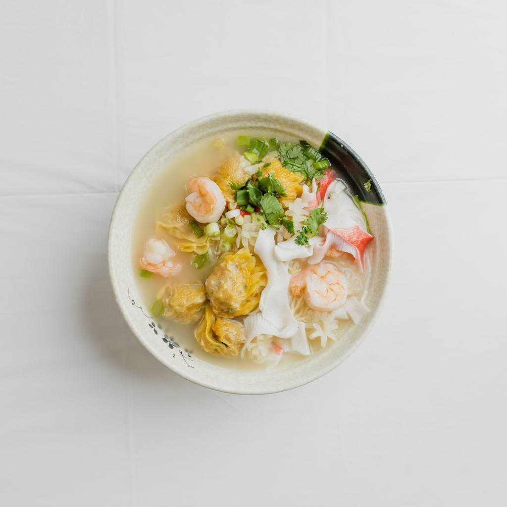 16. Seafood Wonton Noodle Soup · Handmade pork and shrimp wontons  with handmade wgg noodles topped off with squid, shrimp and crab meat, scallions, and cilantro in our chicken miso broth.