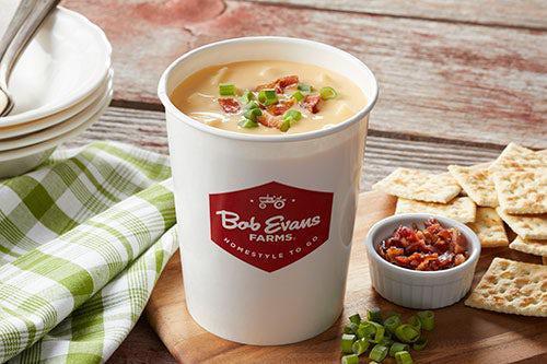 Family Size Cheddar Baked Potato Soup · Large cuts of potato, cured ham, onion, celery and carrots blended together in a perfectly seasoned, satisfying, sharp cheddar cheese base. Topped with bacon. Serves 4.