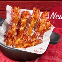 Blue Ribbon Bacon · Five strips of center-cut hardwood-smoked bacon glazed with black pepper maple honey.