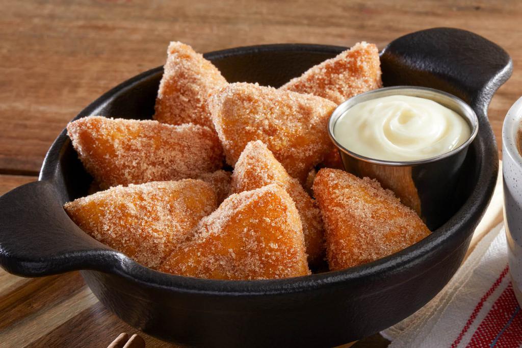 Cinna-Biscuits · Made-to-order fried biscuit dough dusted wth cinnamon sugar and served with warm cream cheese icing…perfect for dipping!