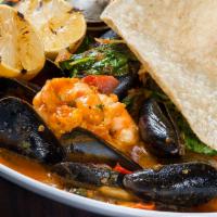 Sopa de Mariscos · Seafood tomato broth with mussels, clams, shrimp, shredded crab meat and white fish.