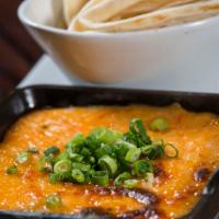 Queso Fundido · Melted chihuahua cheese, guajillo chili bitters, caramelized onions; option to add housemade...