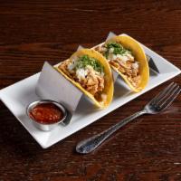 Chicken Tinga Tacos · Shredded chicken cooked in spicy sour annatto broth, onion and  cotija cheese.