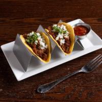 Beef Barbacoa Tacos · Shredded beef, slow-cooked in its own juice with spices and peppers, raw onion and cilantro.