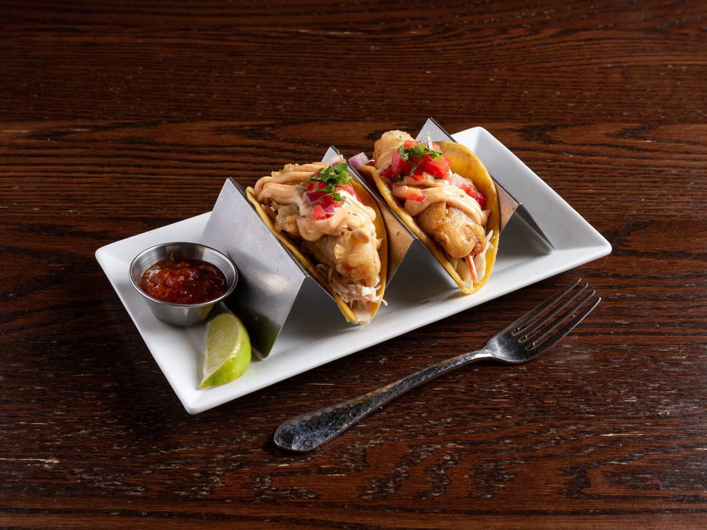 Baja Fish Tacos · Crispy beer battered white fish, cabbage slaw, chipotle dressing and pico de gallo.