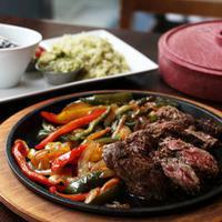 Steak Fajitas · Grilled steak, medley of peppers and onions, rice, beans, guacamole, pico de gallo and flour...