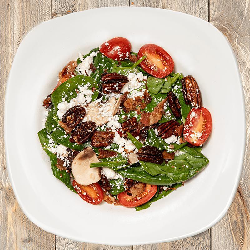 Spinach and Goat Cheese · Spinach, goat cheese, crimini mushrooms, bacon, caramelized onions, grape tomatoes, glazed pecans, and housemade chianti vinaigrette.