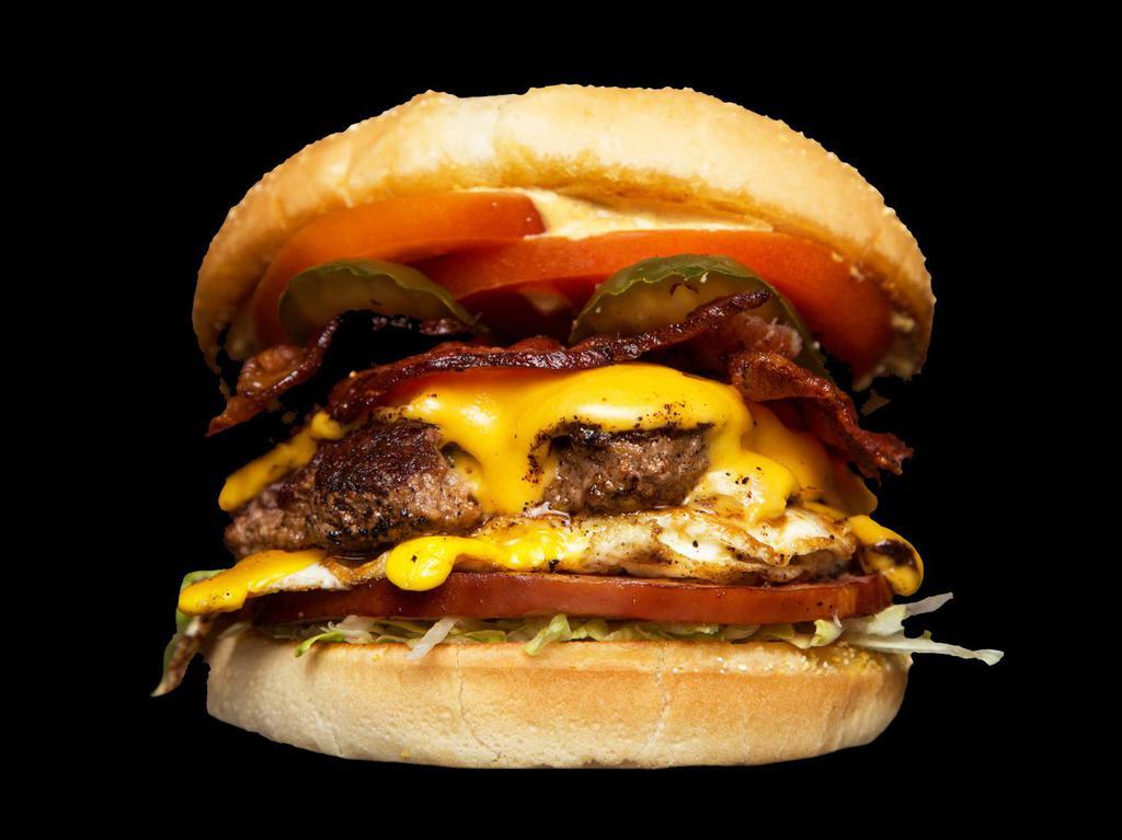 Barnyard Burger · Bacon, ham, egg, American, lettuce, tomato, house sauce, grilled onion & pickle. Every burger comes with bacon and fries.