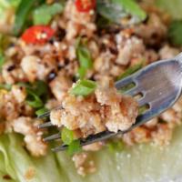 Larb Kai · Ground chicken, rice powder, and onion cooked with spicy lime juice.