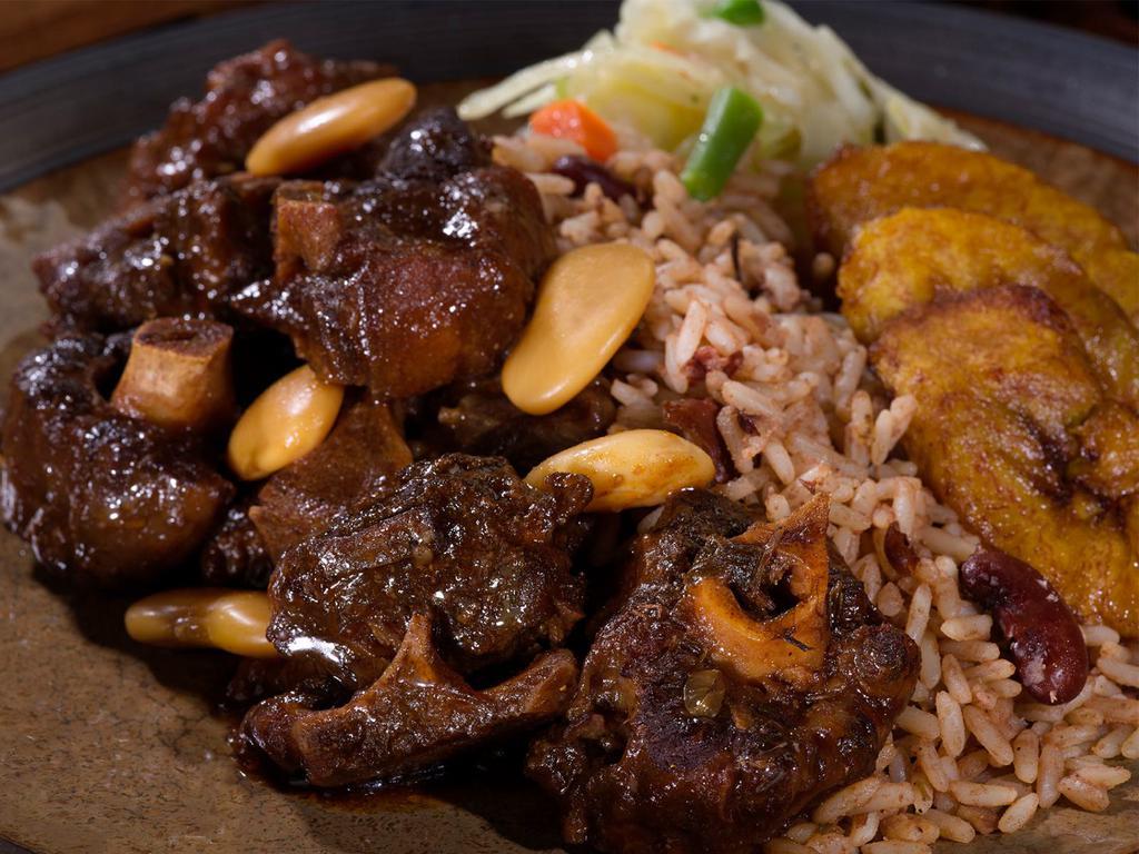 Braised Oxtail Meal · Succulent, slow-cooked, tender braised oxtail in a rich gravy that will make your rice and peas rejoice — a true Caribbean favorite.