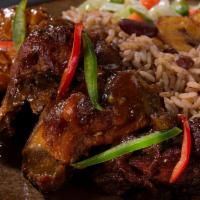 4. Brown stew chicken · Served with rice and peas or white rice and steamed vegetable or collard greens