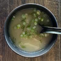 Miso Soup · Plain bowl of miso soup topped with seaweed, soft diced tofu, and diced green onion. Vegetar...