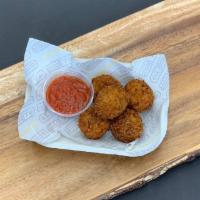 Risotto Balls · Housemade arancini, hand-breaded and stuffed with mozzarella cheese.