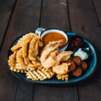 Louisiana Combo · Fried jumbo shrimp, fried catfish, crawfish etouffee, waffle fries and hush puppies.