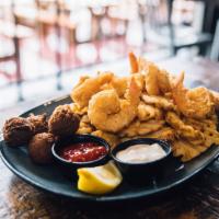 Fried Jumbo Shrimp · Gulf caught, hand battered, waffle fries and hush puppies.