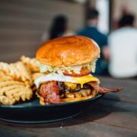 Hangover Burger · Sunny side up egg, american, bacon, waffle fries, dressed and brioche bun.