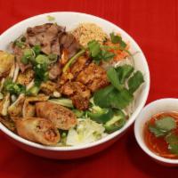 15. Bun Dac Biet · Special noodle bowl combination grilled chicken, grilled pork, shrimp and Vietnamese egg roll.