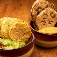 Guacamole and Hummus · Served with homemade eggplant chips, and gluten free tortilla chips.