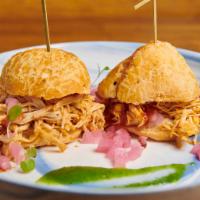 Chicken Sliders · Pulled chicken, homemade BBQ sauce, pickled onions on Brazilian gluten-free cheese bread.