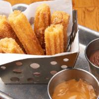 Churros · fried-dough pastry coated with cinnamon and sugar, served with homemade dulce de leche and h...