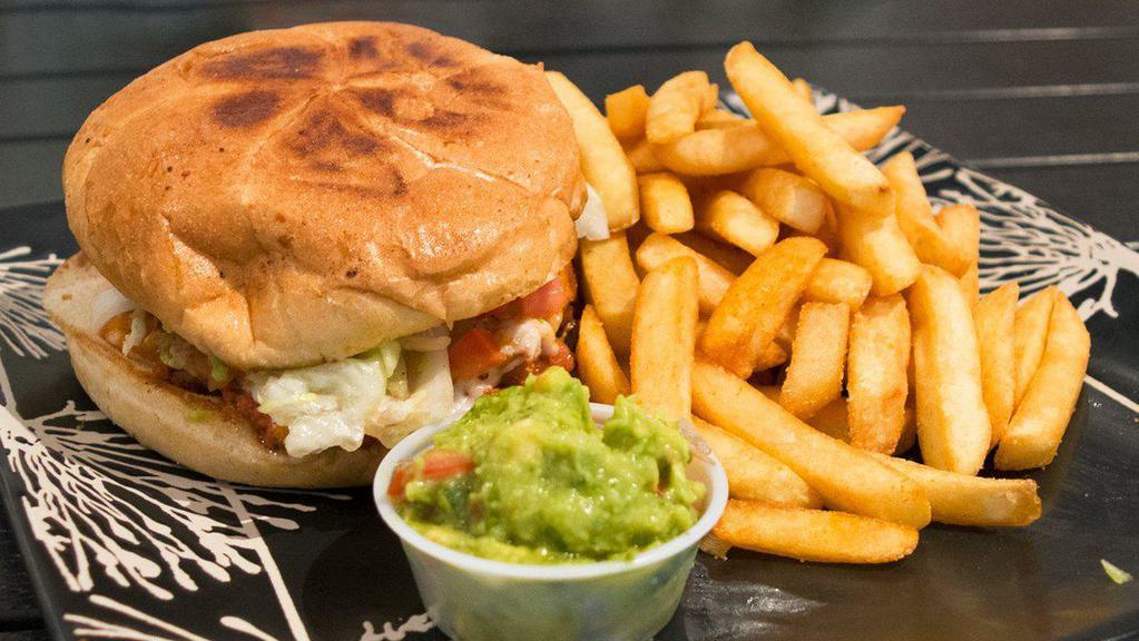 Torta · Bread bun, avocado, beans, cheese, onion, tomato, and choice of meat served with fries.