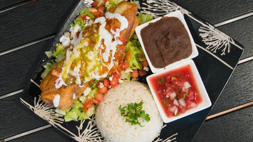 Chimichanga · Fried flour tortilla with beans, cheese, and your choice of meat, served with rice, and a green salad topped with fresh cheese and sour cream.