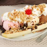 Banana Split Breyer’s IceCream  · Three scoops of Breyer’s ice cream chocolate vanilla and strawberry with a whole banana topp...
