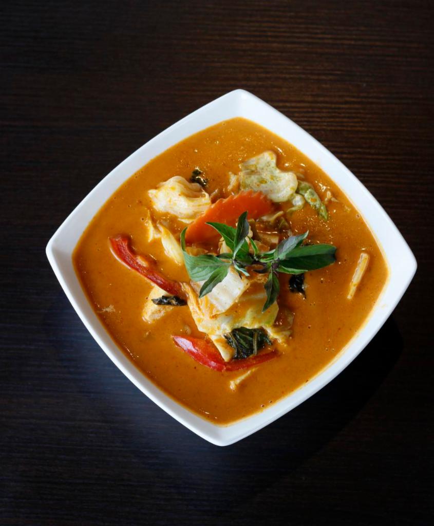 39. Gang Dang · Red curry. Gluten-free. Choice of spice level. Choice of style. Red curry with eggplants, red bell peppers, green beans, bamboo shoots, and fresh basil.